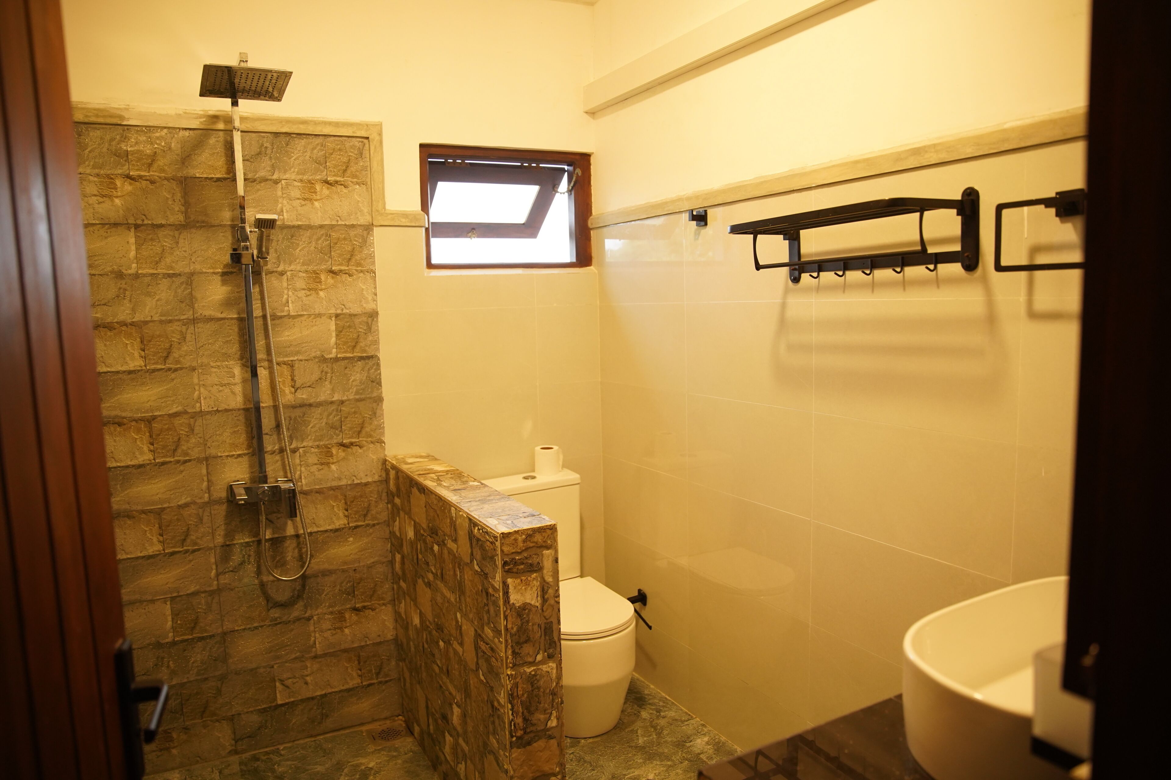 A bathroom with a shower, toilet, and sink.