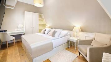 A modern bedroom with a bed, a desk, a chair, and a wardrobe.