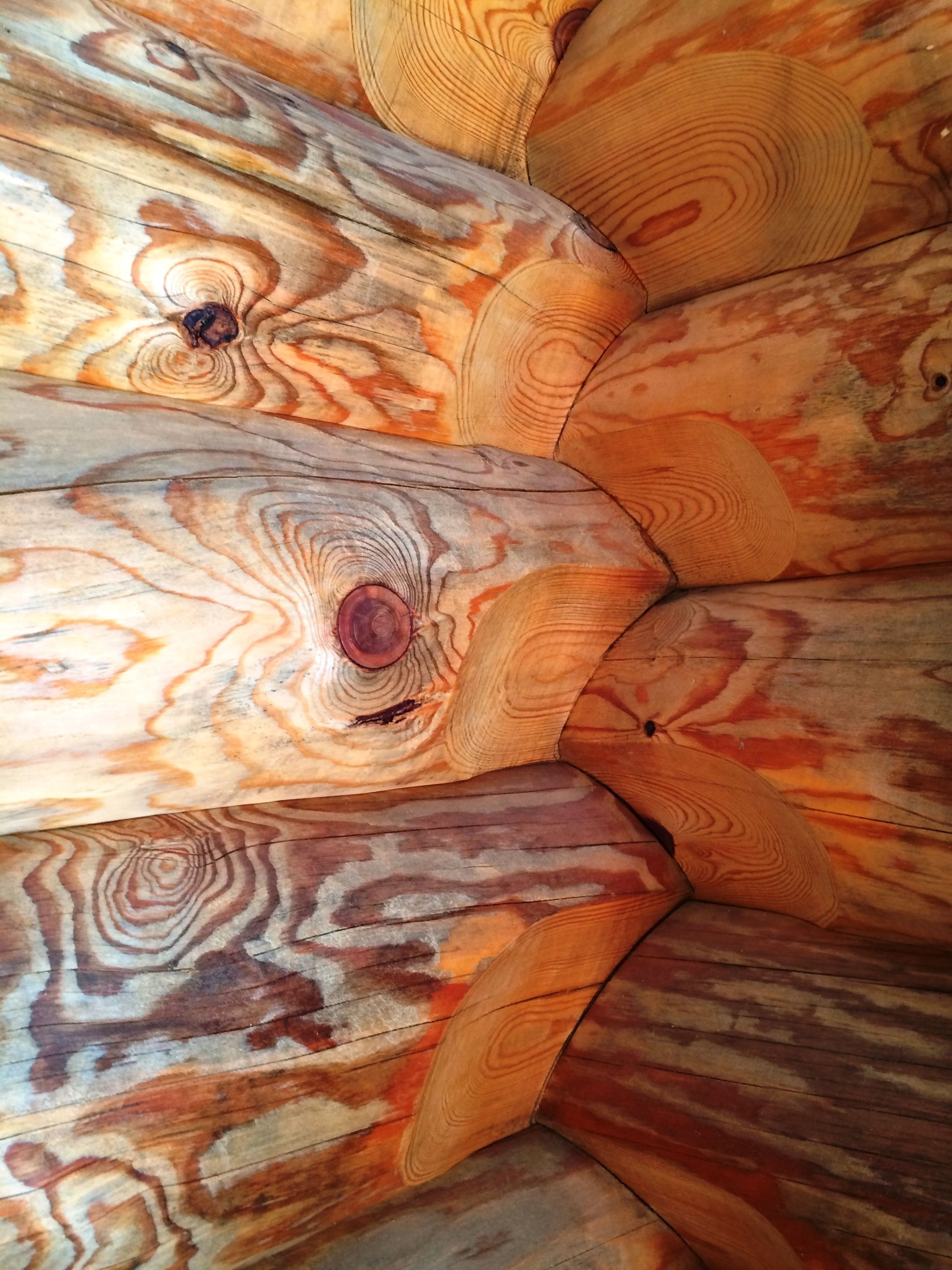 A close-up of a wooden surface with a natural grain pattern and knots.