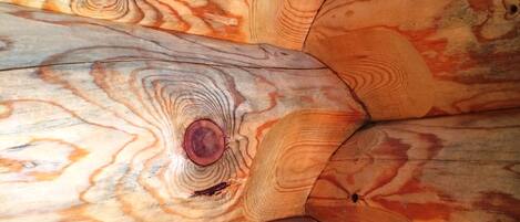 A close-up of a wooden surface with a natural grain pattern and knots.