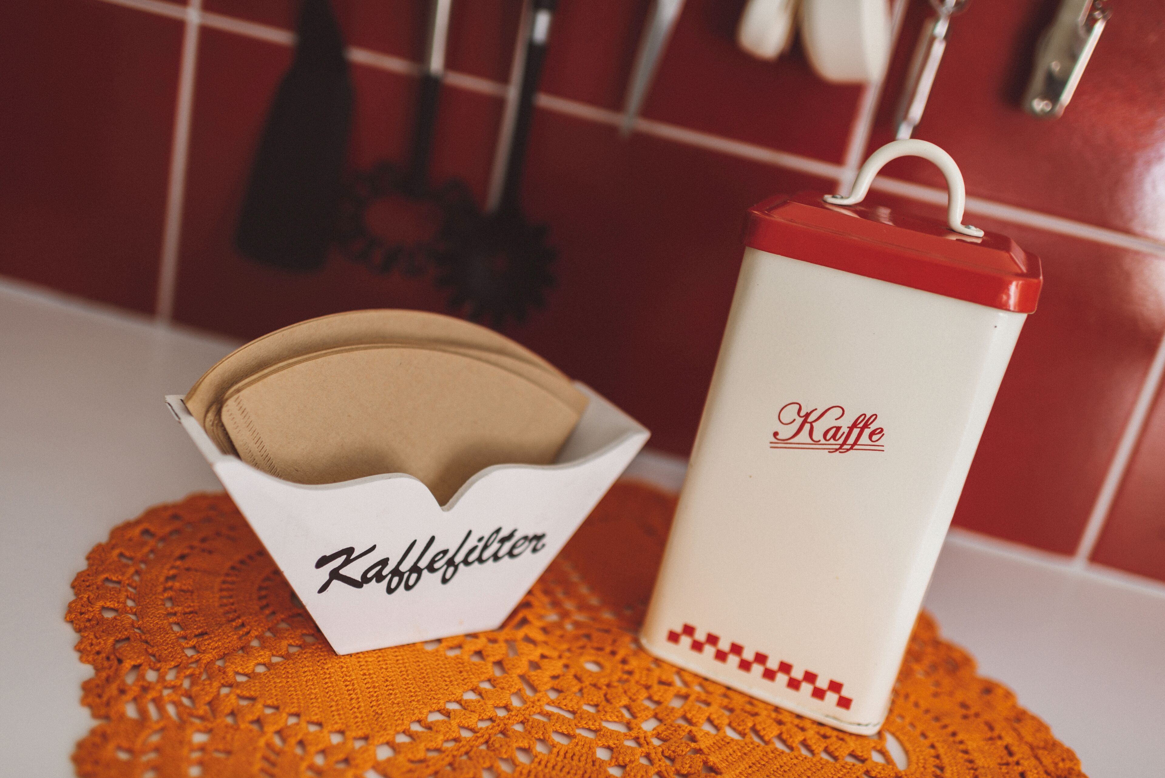 A coffee maker and a filter basket on a kitchen counter.