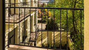 A multi-story building with balconies, a clear sky, and surrounding greenery. - Riga Lux Apartments - Ernesta (Riga)
