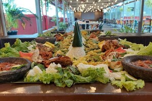 A buffet with various dishes and condiments. - Riez Palace Hotel (East Tegal)