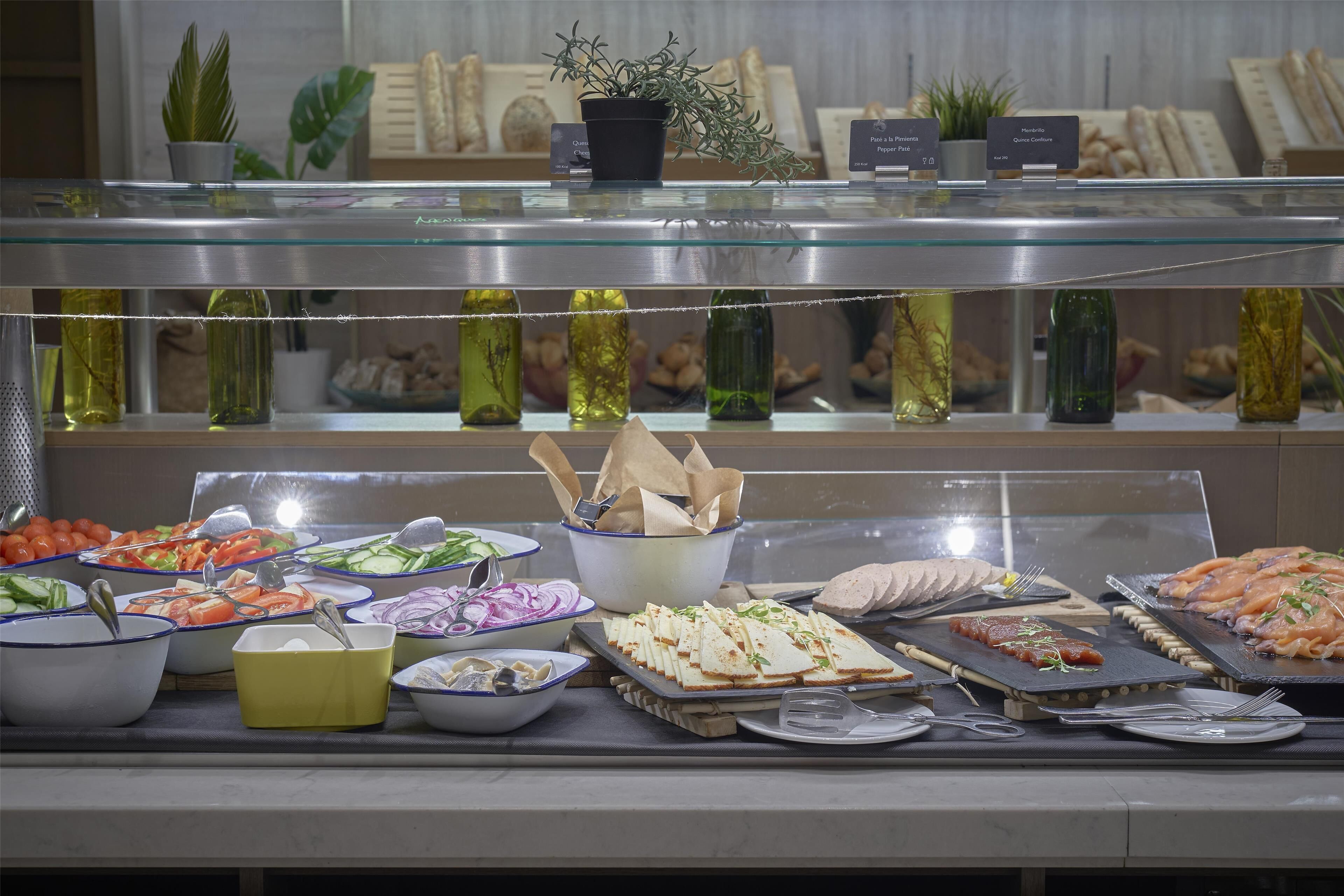 A buffet with various food items and condiments.