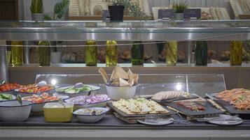 A buffet with various food items and condiments.