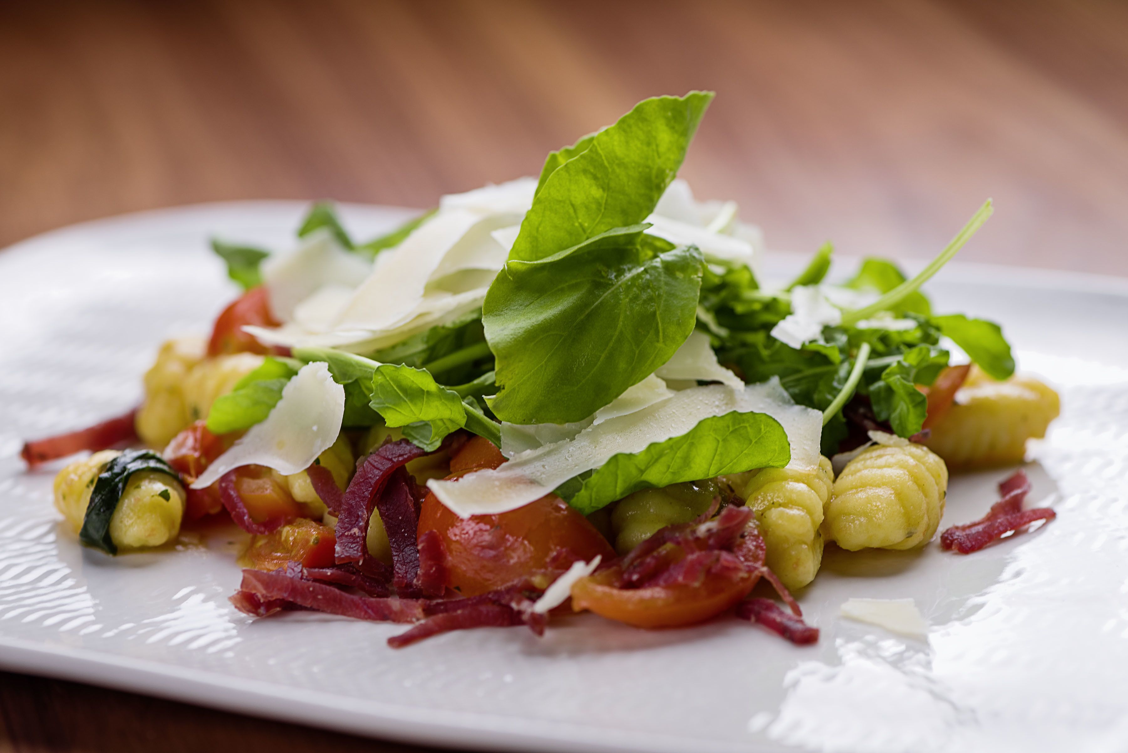 A plate of food with various vegetables and cheese.