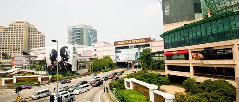 A multi-story building with a large billboard advertising a brand.