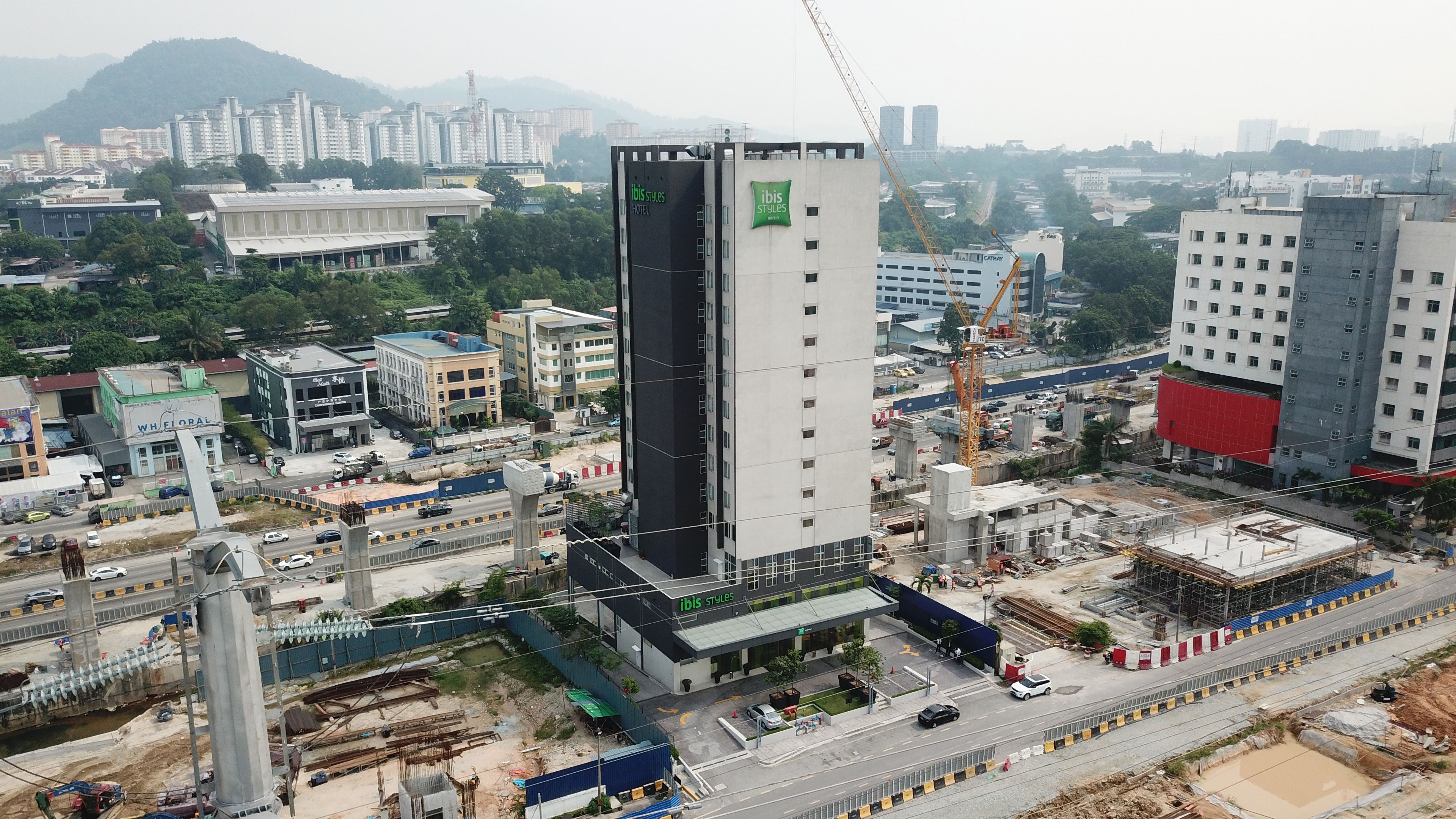 A hotel with a modern design, featuring a prominent vertical structure and a flat roof.