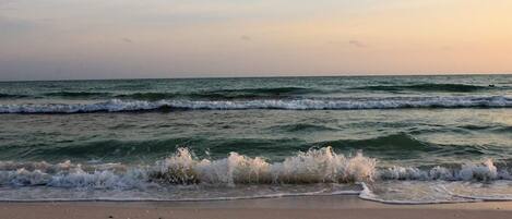 A beach with waves gently crashing onto the shore.