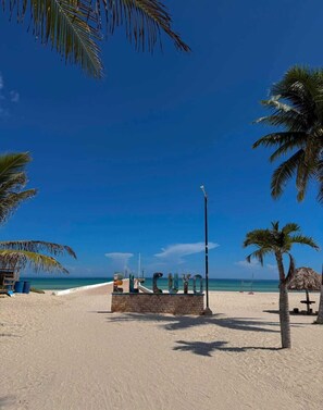 Sur la plage, sable blanc, serviettes de plage, volleyball