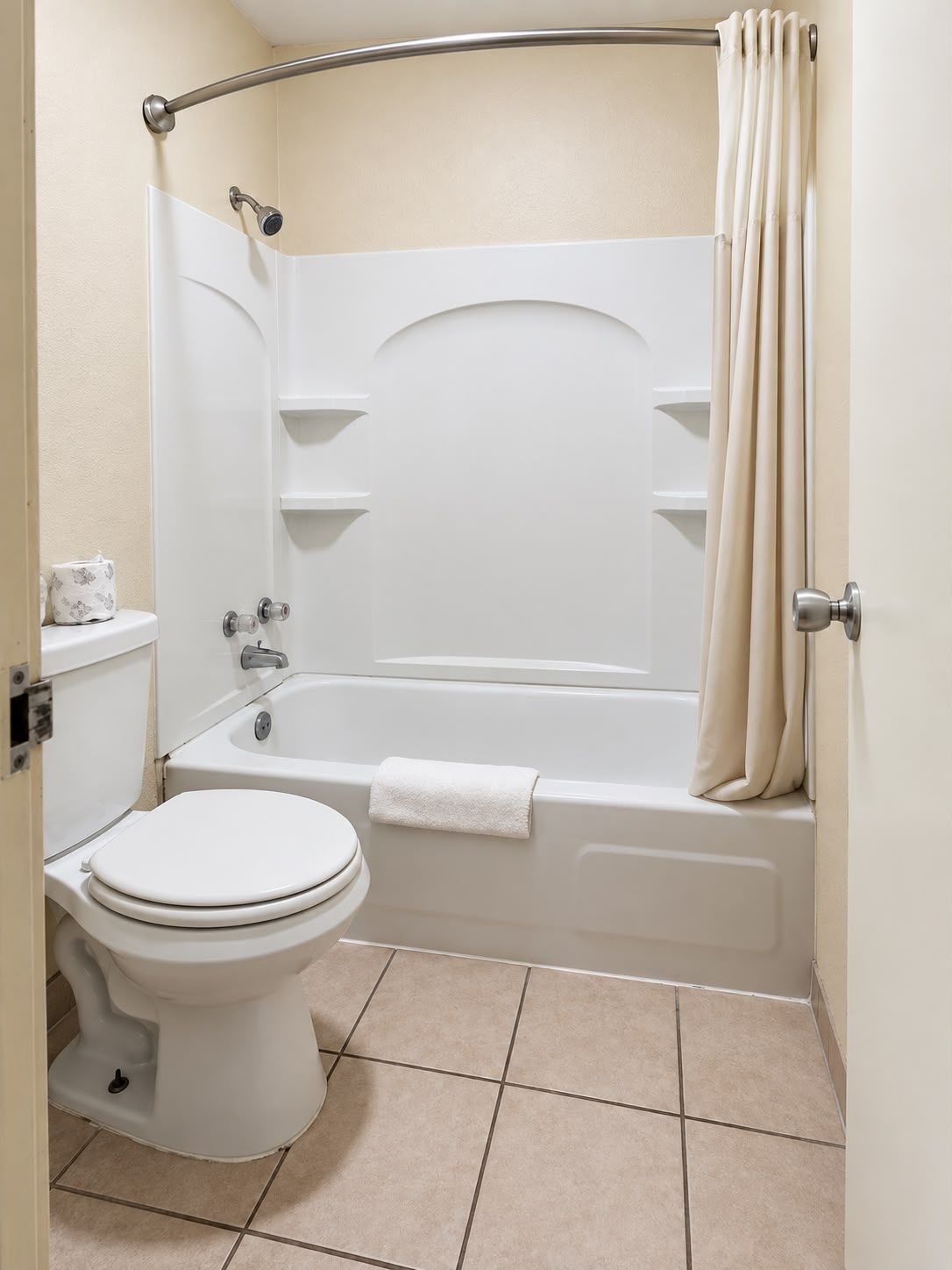 A bathroom with a toilet, bathtub, and shower curtain.
