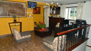A living room with a sofa, a coffee table, and a staircase. - Residencial Carlos (Lima)