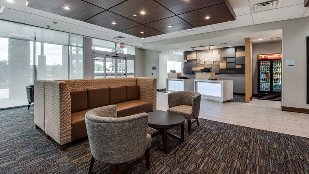 A modern lobby with a seating area, a kitchenette, and a refrigerator stocked with beverages. - Holiday Inn Express & Suites Dallas North - Addison by IHG (Dallas)