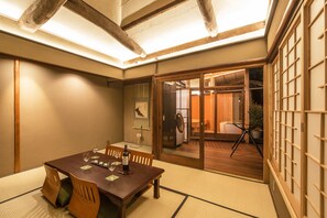 Suite, 2 Bedrooms, Temple Garden View | Living area | Flat-screen TV, tablet - Machiya Maya Gion (Kyoto)