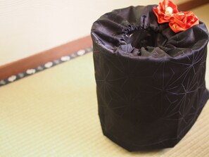A black fabric item with a geometric pattern and a red decorative element. - Kikkake Green and Mt.Fuji - Hostel (Fujiyoshida)