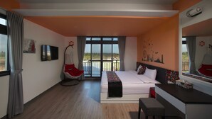A modern hotel room with a large bed, a desk, a chair, and a balcony with a view. - Happy Together B&B (Wujie)