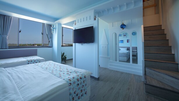 A hotel room with two beds, a TV, a staircase, and a view of the outside. - Happy Together B&B (Wujie)