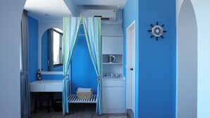 A room with a blue and white color scheme, a wooden floor, a bed with a striped canopy, a desk with a mirror, and a wall clock. - Happy Together B&B (Wujie)
