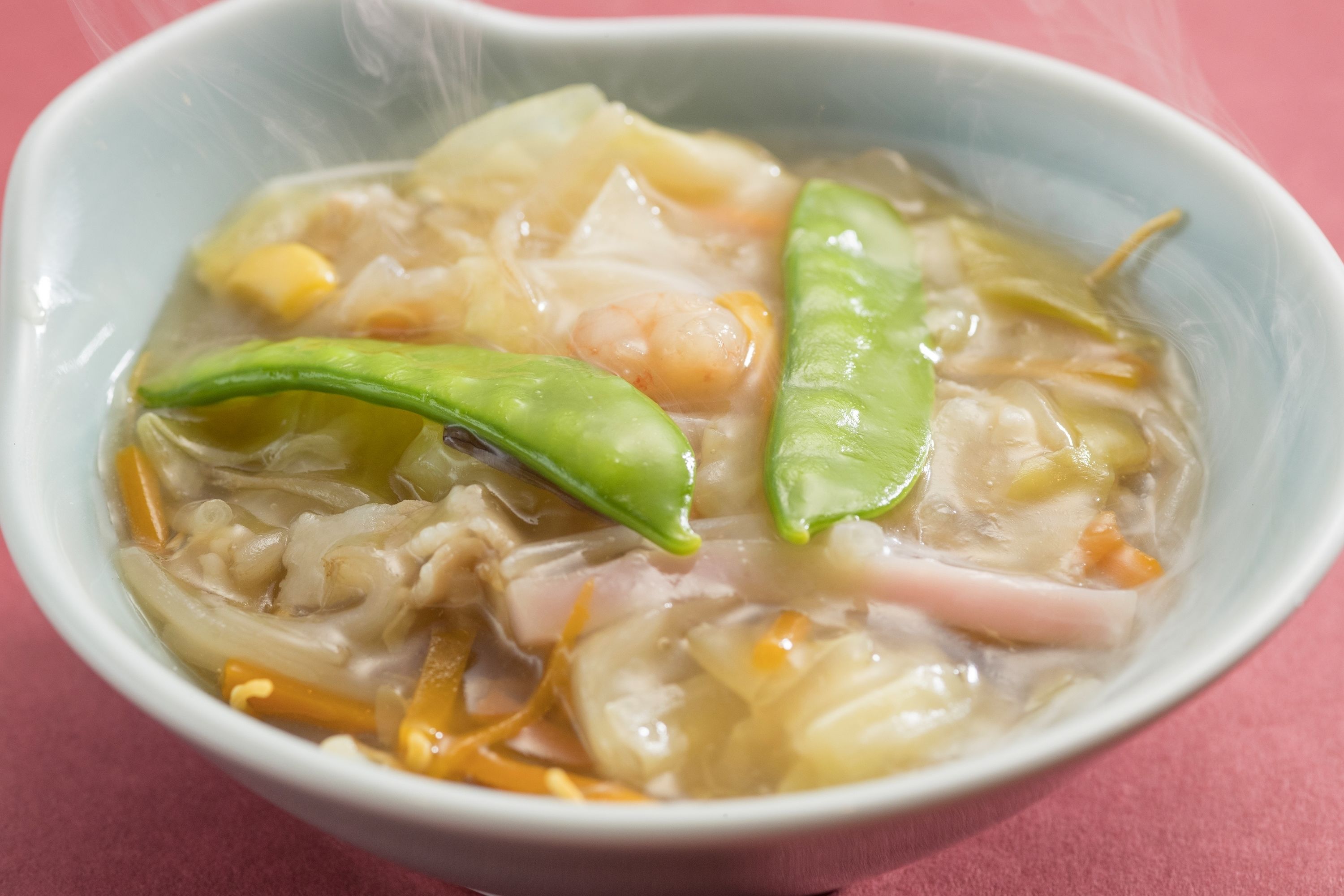 A bowl of soup with various ingredients.