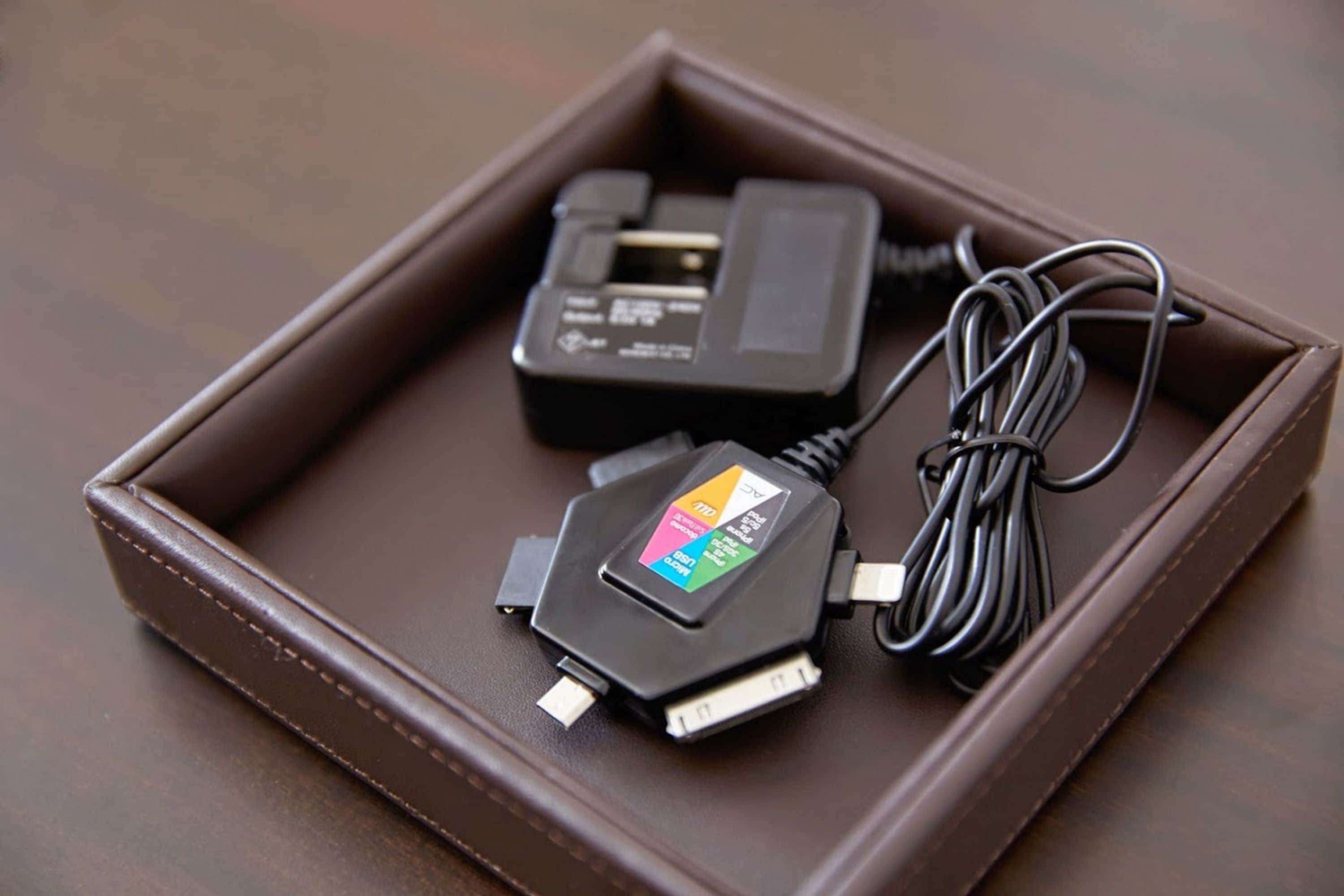 A brown leather case with two electronic devices inside.
