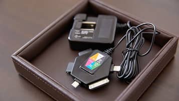 A brown leather case with two electronic devices inside.
