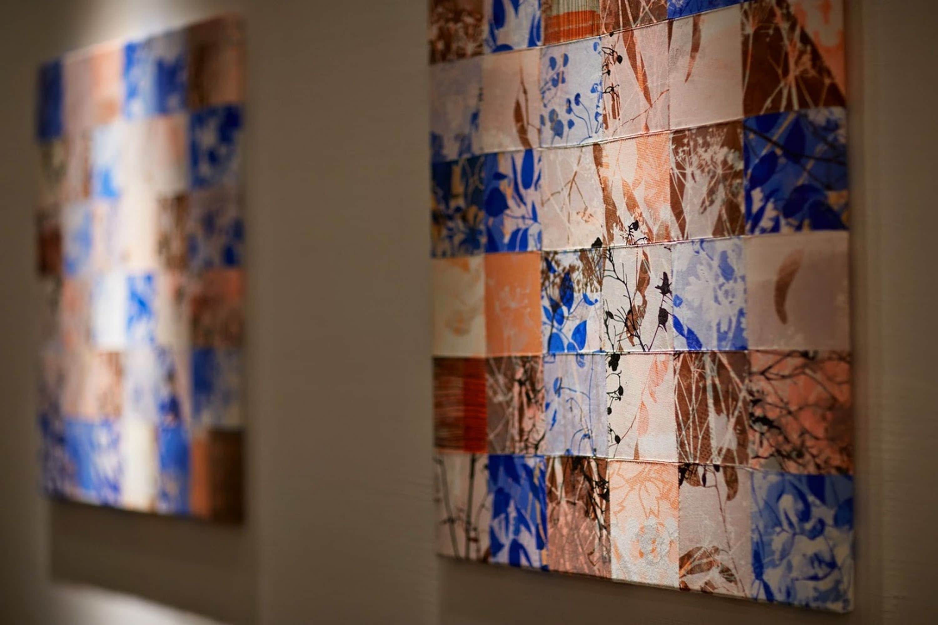 A wall with a patterned artwork.