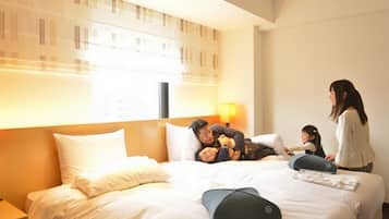 A hotel room with a large bed, a nightstand, and a window with blinds.