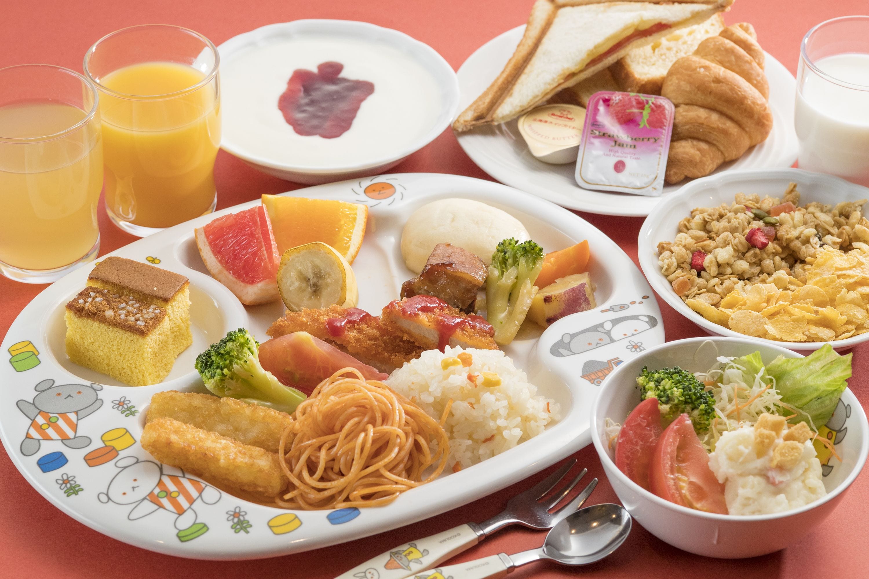 Une table garnie de divers aliments pour le petit-déjeuner, notamment des toasts, des croissants, des céréales et un bol de soupe.