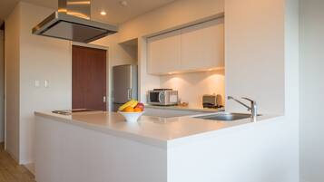 Una cocina moderna con una isla central, electrodomésticos de acero inoxidable y un microondas.