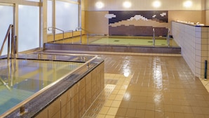 A swimming pool with tiled walls and a wooden ceiling, featuring a large window and a tiled mural on the back wall. - Quad Inn Yokote (Yokote)