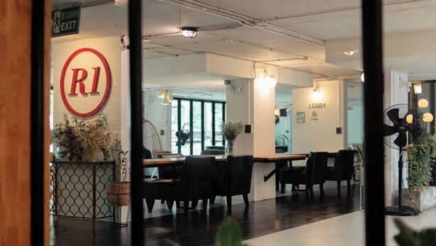 An indoor area with a reception desk, a 'Lobby' sign, and seating arrangements. - R1 Nimman Hotel Chiangmai (Chiang Mai)