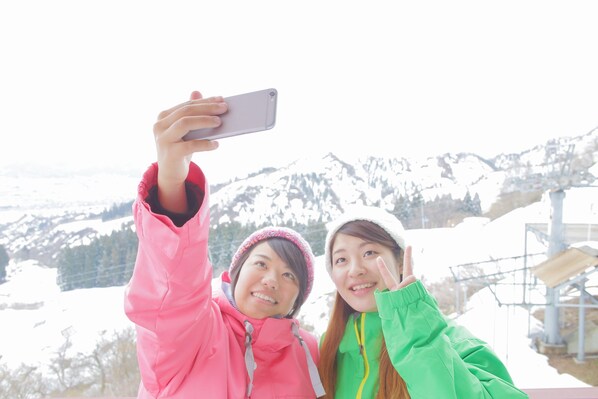 Two people taking a selfie with a smartphone.