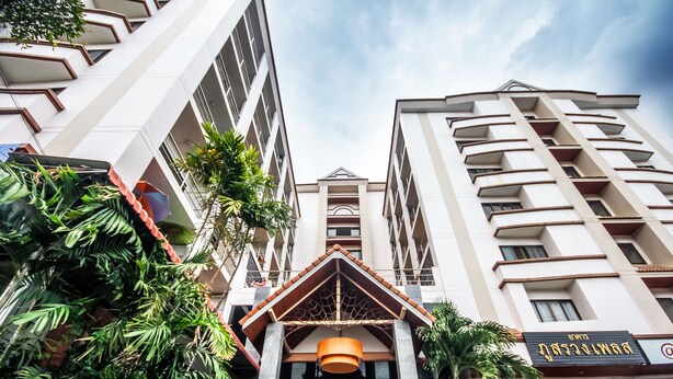 A modern hotel entrance with a prominent entrance canopy and a sign indicating a restaurant. - Phusuang Place (Chiang Mai)