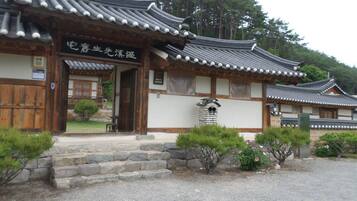 A traditional Japanese building with a tiled roof and wooden walls.