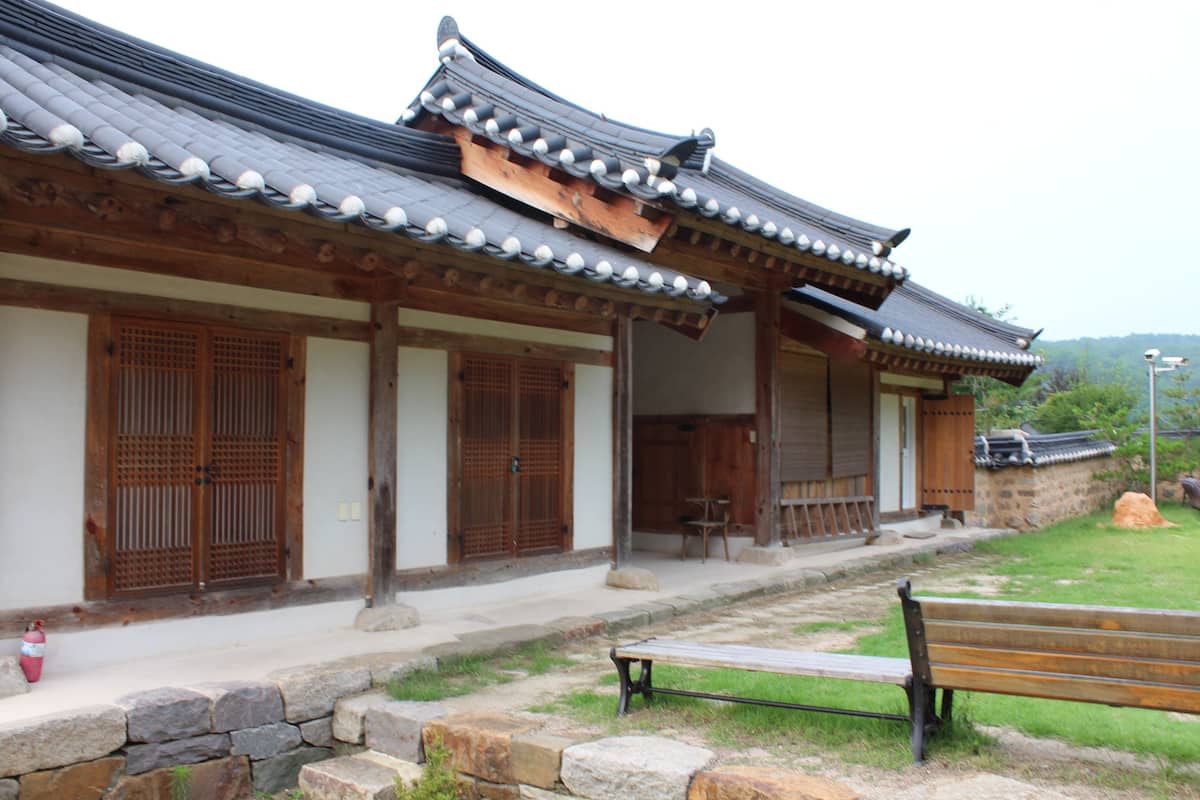 A traditional building with a tiled roof and wooden doors.