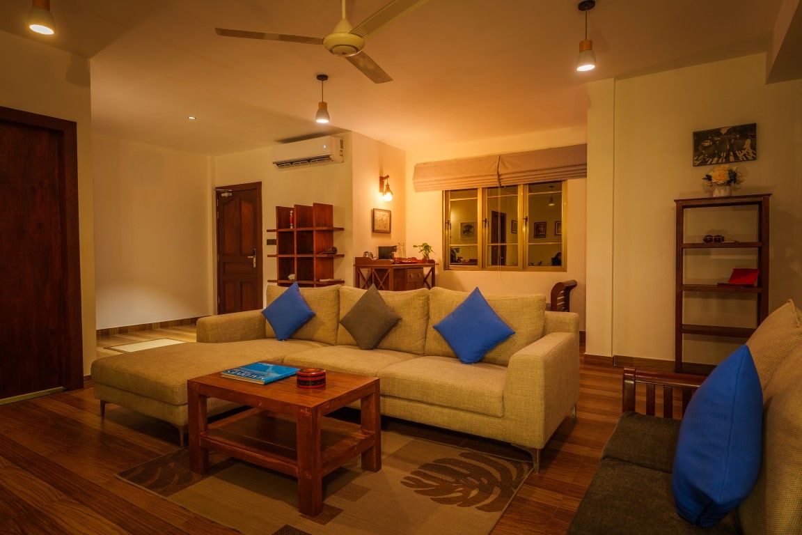 A living room with a sofa, a coffee table, and a bookshelf.