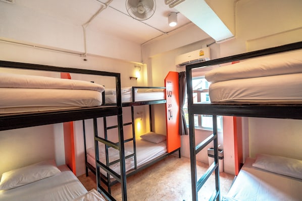 A bunk bed room with a window, a fan, and a wall-mounted heater. - Mad Monkey Chiang Mai - Hostel (Chiang Mai)