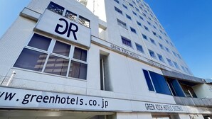 A tall building with the signage "GREEN RICH HOTELS" and "DR" on the facade.
