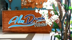 A wooden reception desk with the name "Ala Dos Santos Hotel" in stylized lettering. - AlaDeniz Hotel (Istanbul)
