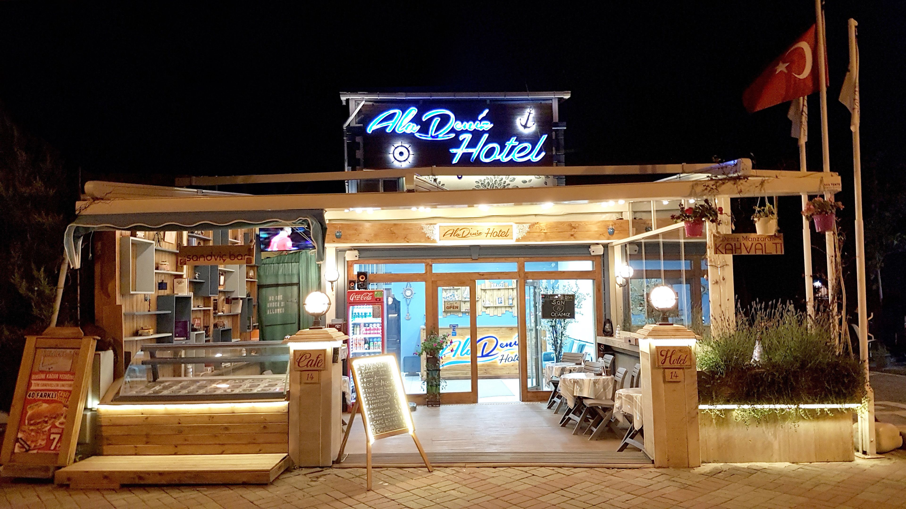 A hotel with a neon sign, a sandwiched bar, and a Coca-Cola refrigerator.
