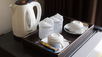 A tray with a Seagull kettle, two glass tumblers, and a chocolate bar.