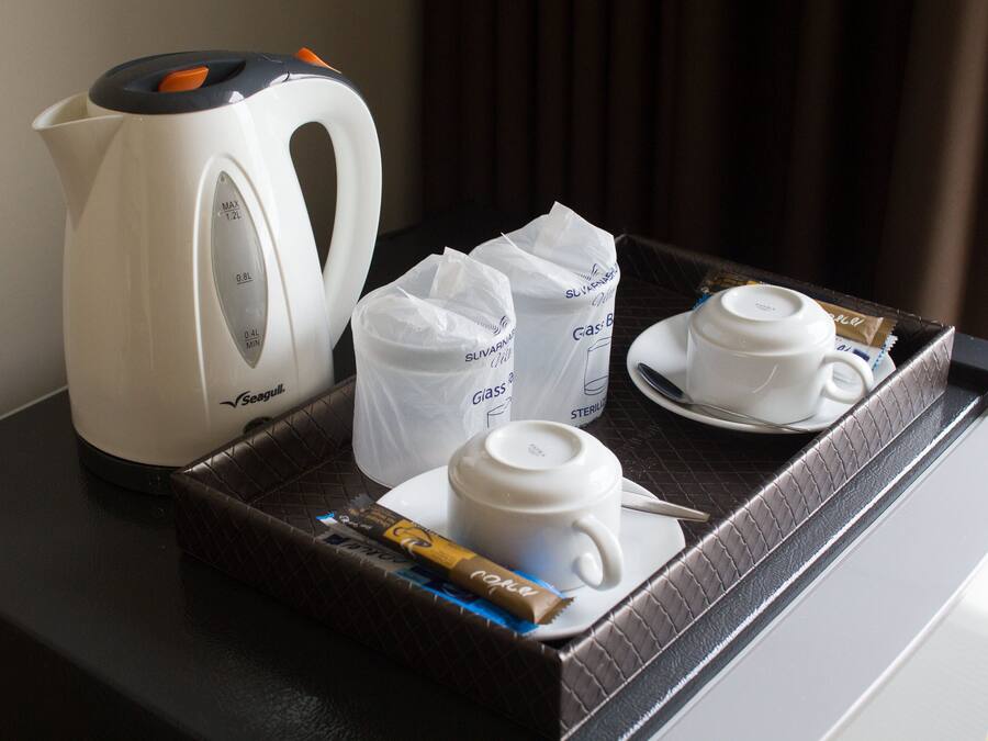 A tray with a Seagull kettle, two glass tumblers, and a chocolate bar.