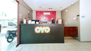 A reception desk with a 'YOYO' sign, a Dell computer, a refrigerator, and various informational signs. - Hotel O Midah Inn Puchong (Seri Kembangan)