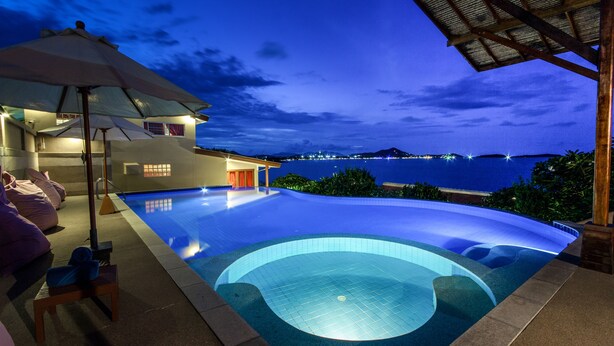A swimming pool with a view of the sea at dusk. - Boujis Boutique Resort (Koh Samui)