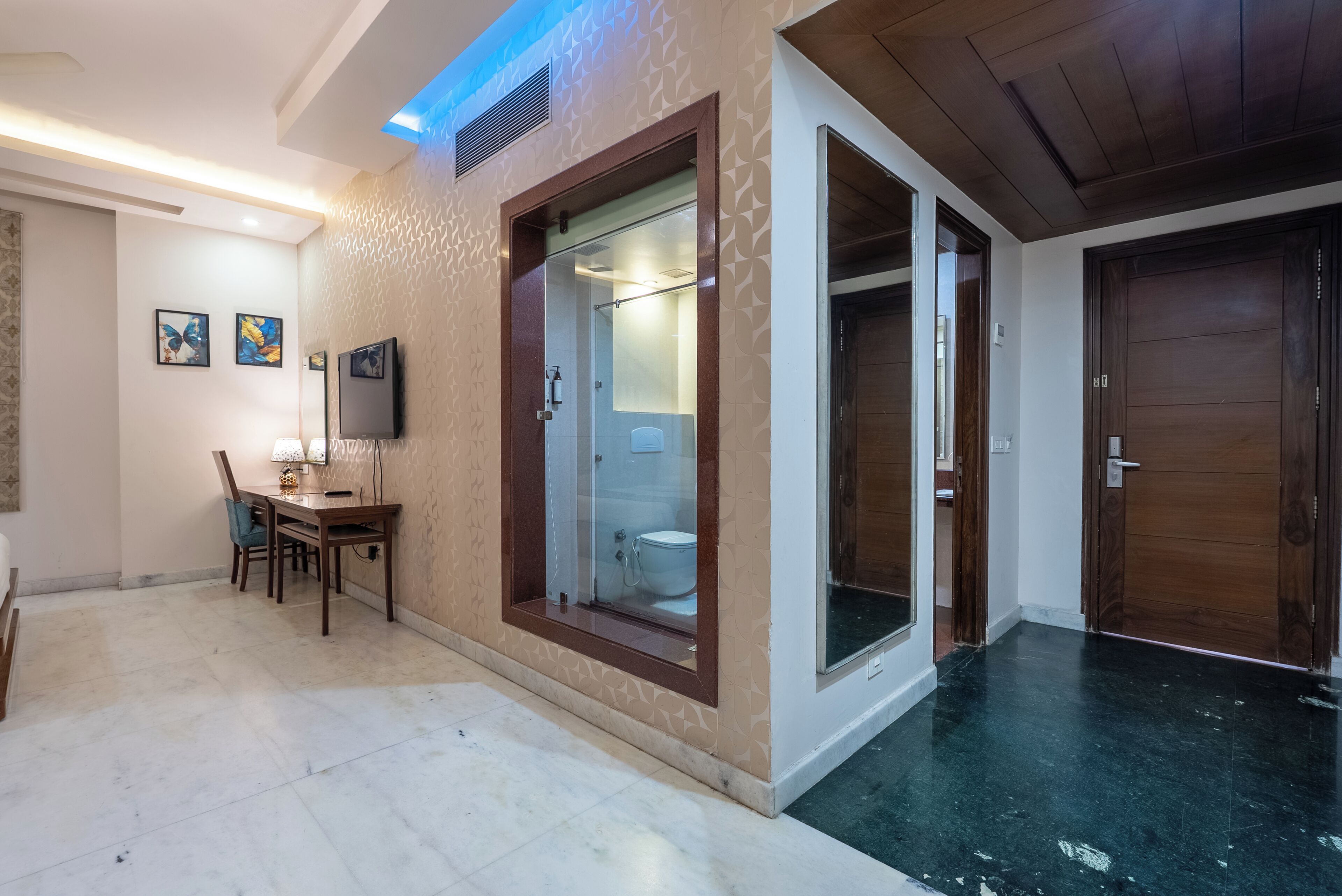 A modern bathroom with a glass-enclosed shower, a toilet, and a sink.