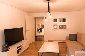 Lägenhet City - 1 sovrum | Vardagsrum | 1-centimeters platt-tv med kabelkanaler och tv