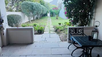 Step into a serene oasis with a tranquil garden and patio area, perfect for relaxation.