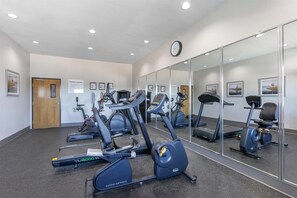 A fitness center with treadmills, elliptical machines, and stationary bikes.