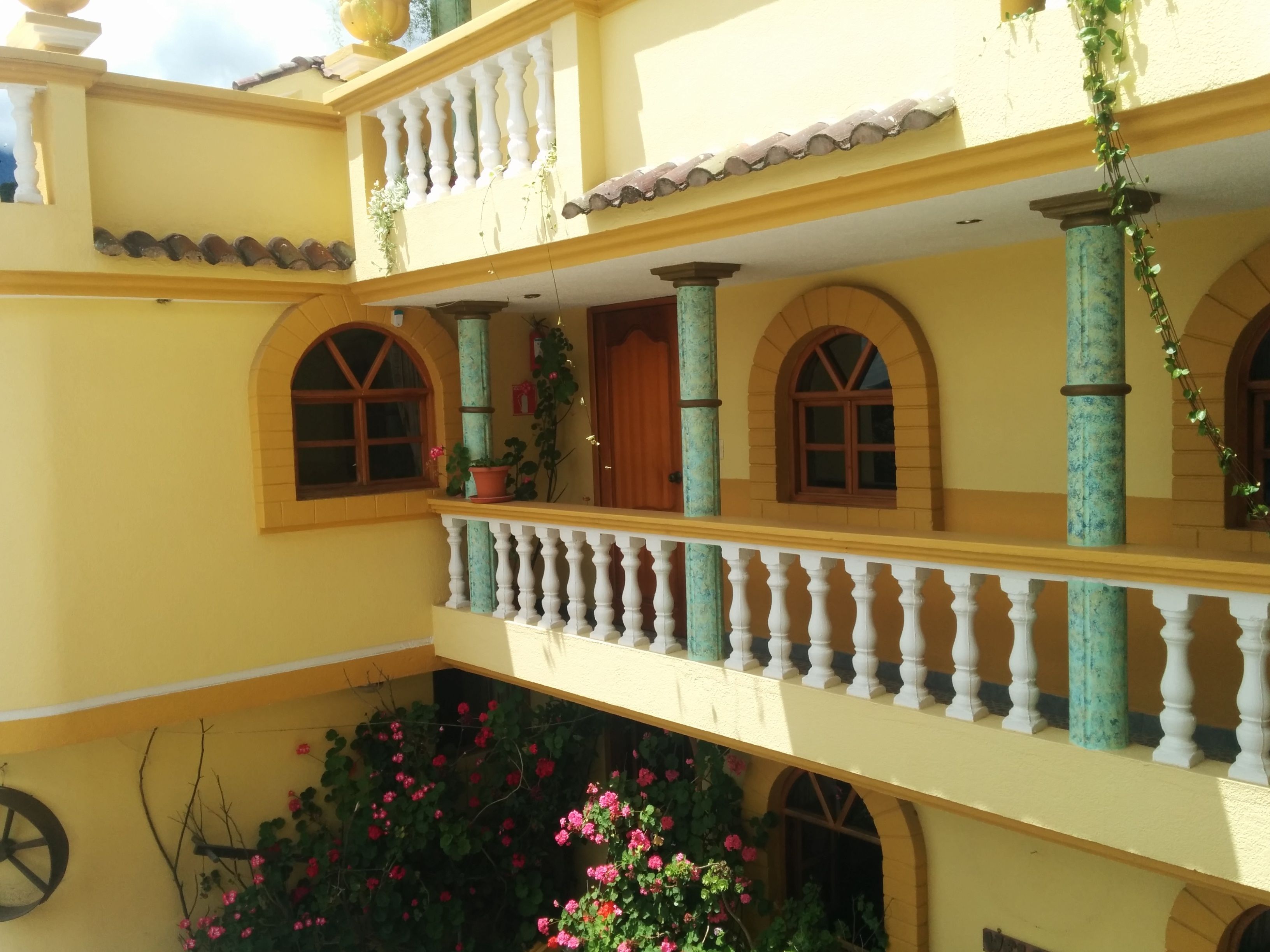 A multi-level building with balconies, arched windows, and columns.