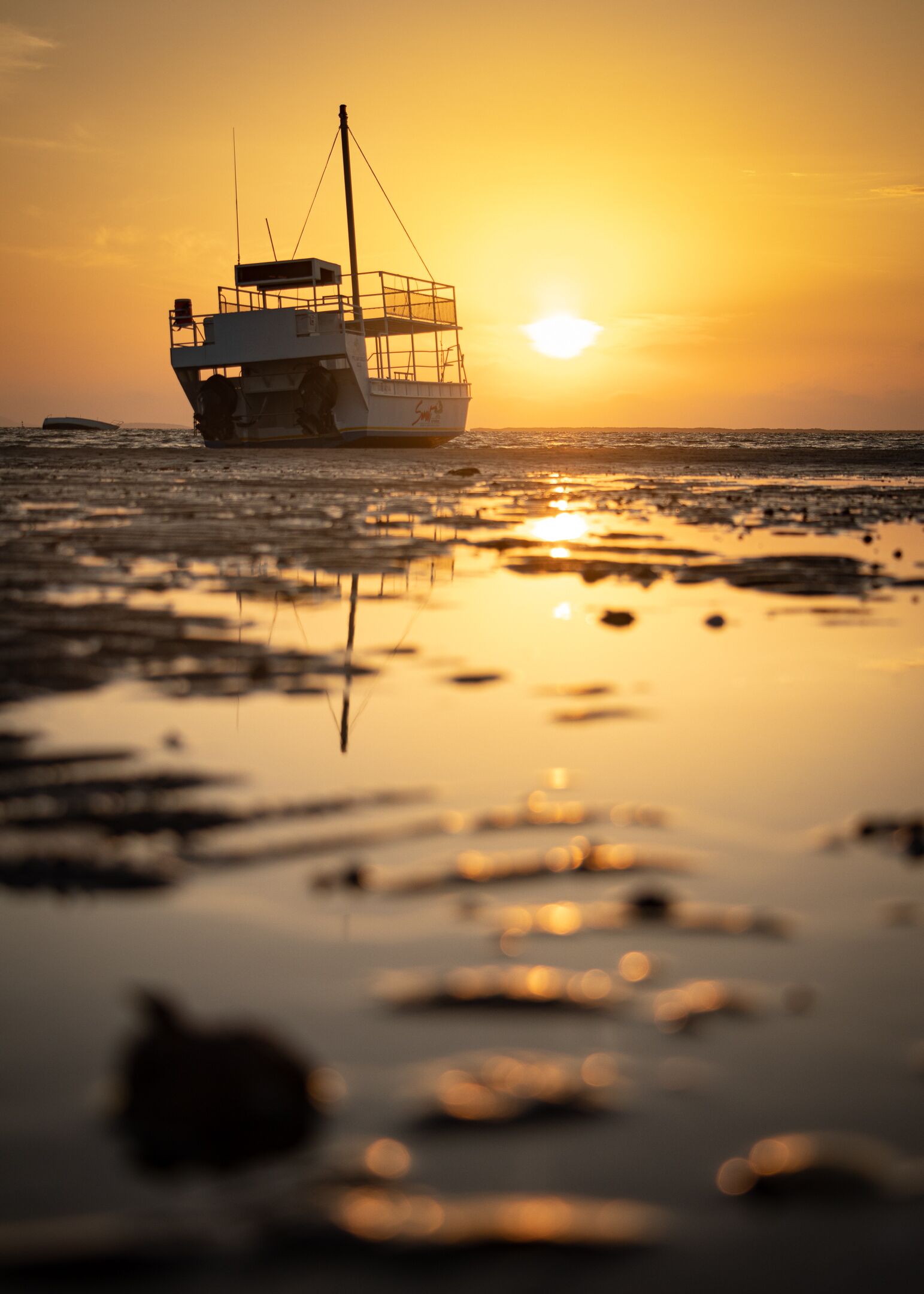 A boat on calm waters during sunset.